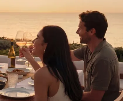 Travellers enjoying a private seaside dinner