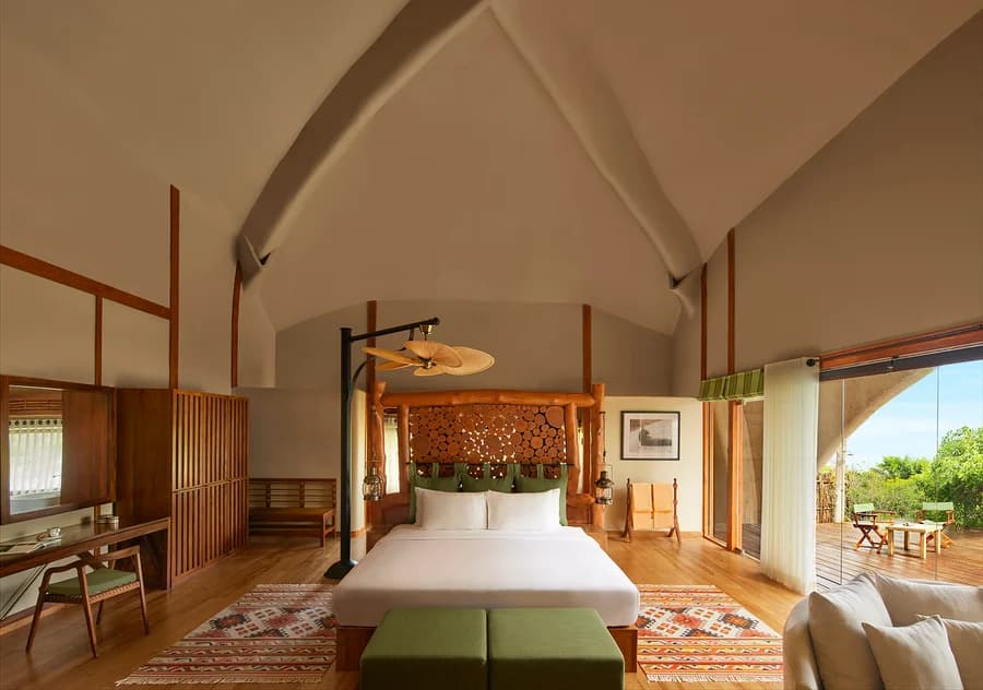 Luxury Pool Cabin bedroom at Uga Chena Huts with a king bed and private deck