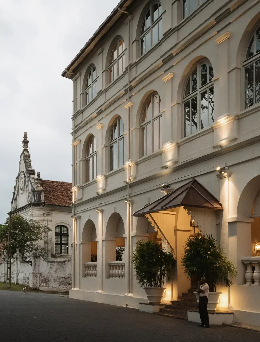 Amangalla’s illuminated colonial façade at dusk within Galle Fort