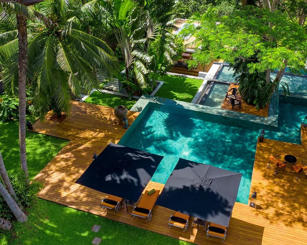 Aerial view of the shared infinity pool beside Haritha’s one-bedroom colonial mansion