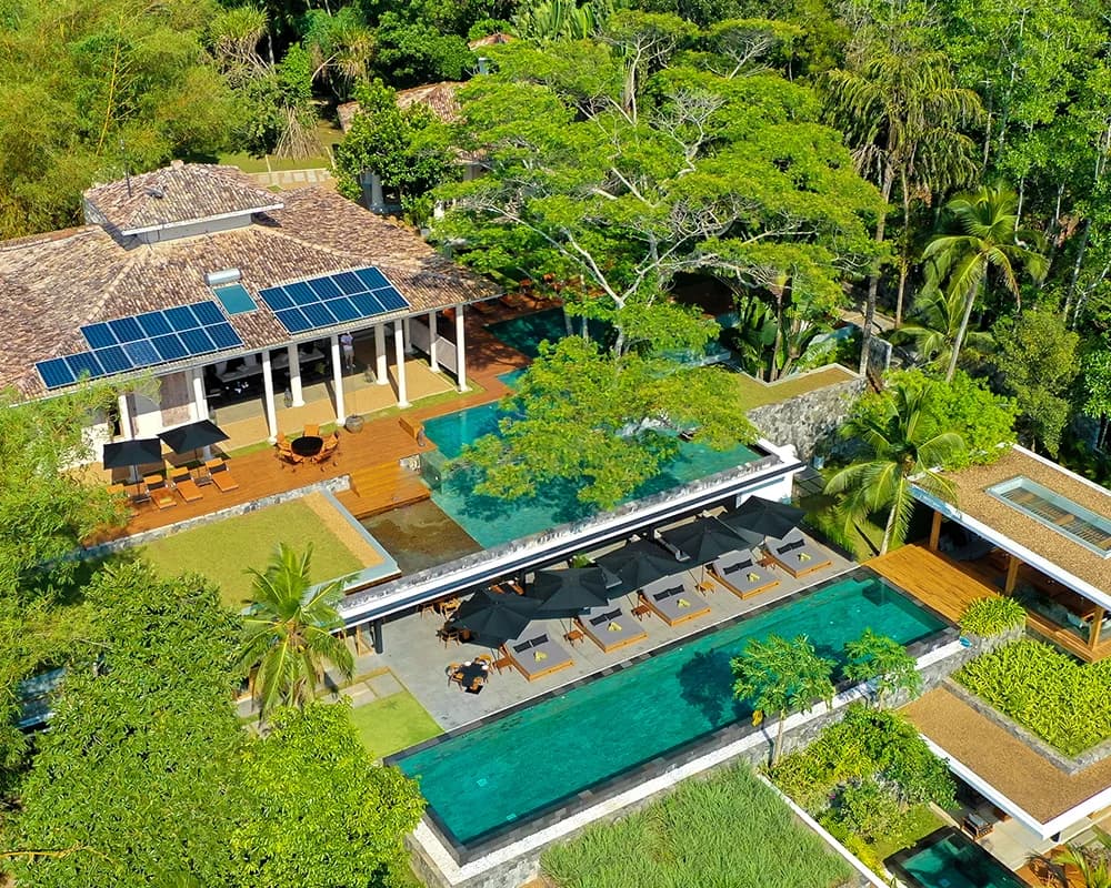 Aerial view of Haritha’s infinity pool and open-air restaurant amid tropical greenery