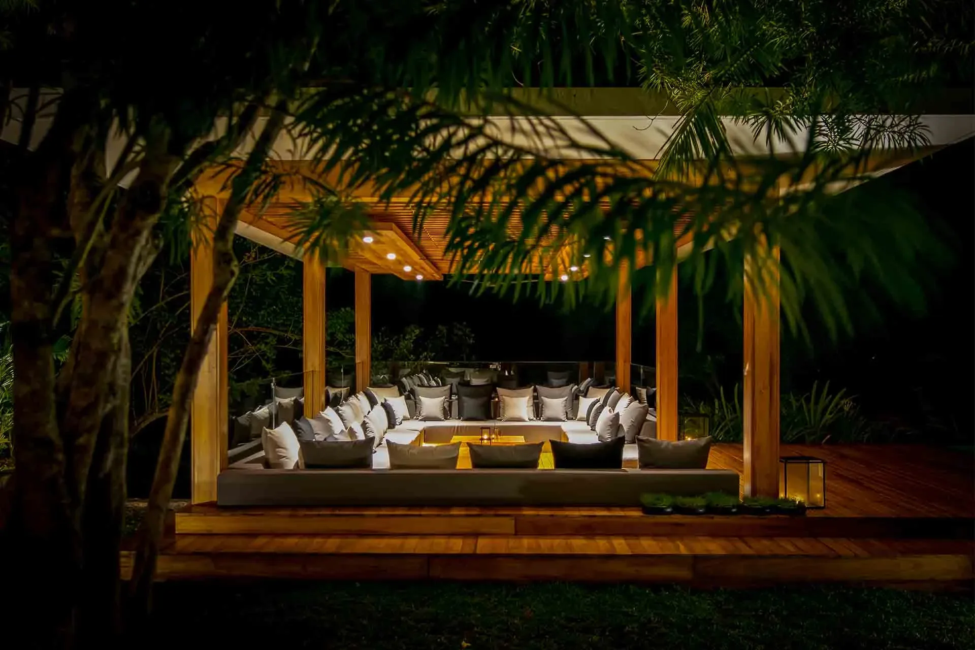 Candlelit dining pavilion surrounded by tropical foliage at Haritha Villas + Spa