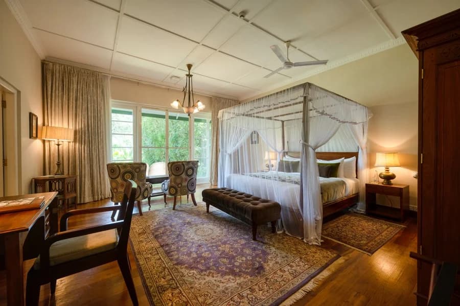 Garden Suite with a four-poster bed, sitting area and garden views at Ceylon Tea Trails