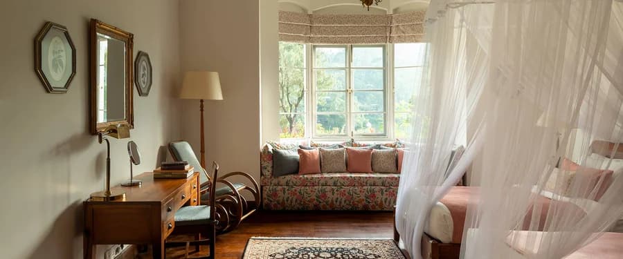 Luxury Room at Ceylon Tea Trails with period furnishings and a sunlit sitting area